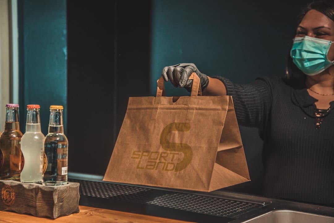 Customer collecting a prepaid pickup order from a restaurant shelf