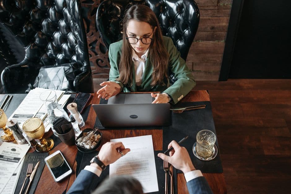 Restaurant operators reviewing a shared digital menu plan for multiple locations