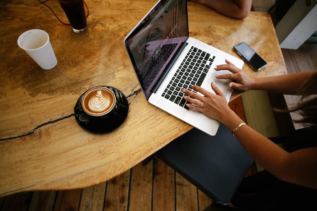 Restaurant manager migrating a menu from a document into a structured digital menu on a laptop.