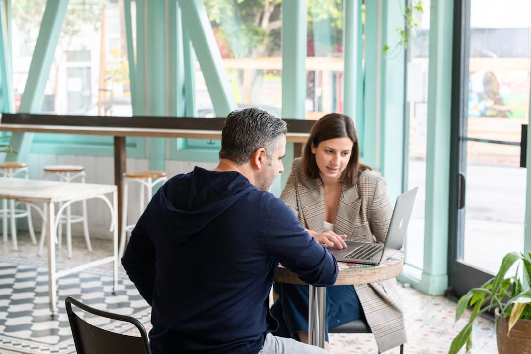 Restaurant manager reviewing imported digital menu data on a laptop before publishing.