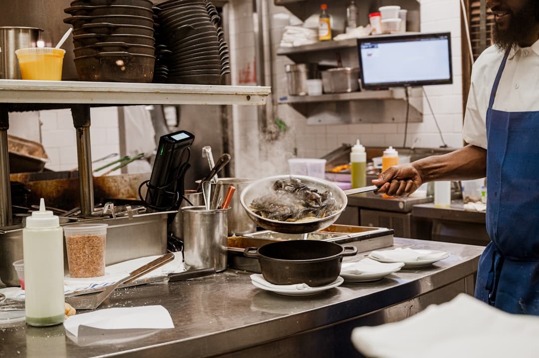 Restaurant manager checking online ordering prep time and pickup settings on a tablet