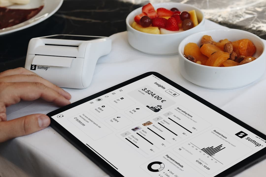 Restaurant manager calculating digital menu software ROI beside a QR code menu display.