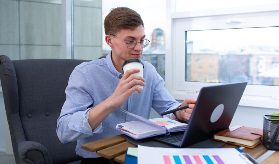 Restaurant manager reviewing weekly menu analytics and planning changes on a laptop.
