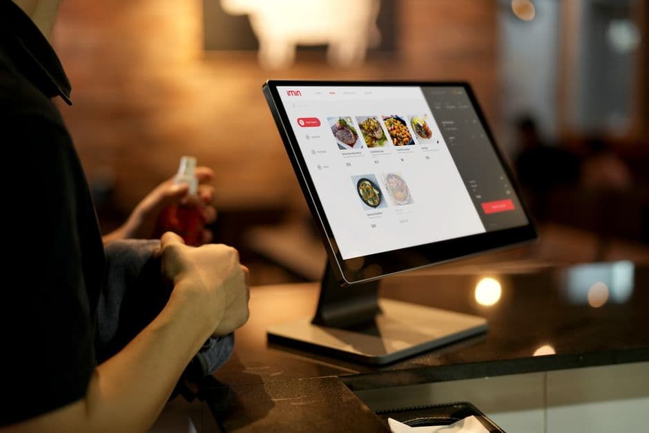 Restaurant manager reviewing featured specials and bundles on a digital menu