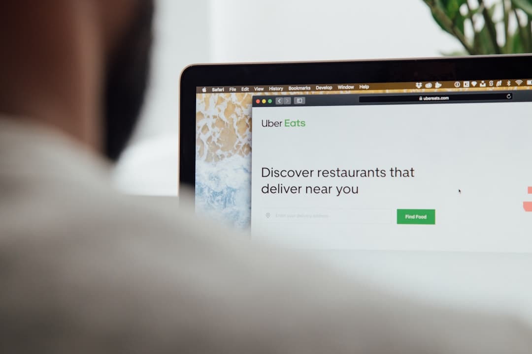 Restaurant manager reviewing delivery zone settings for online ordering on a laptop