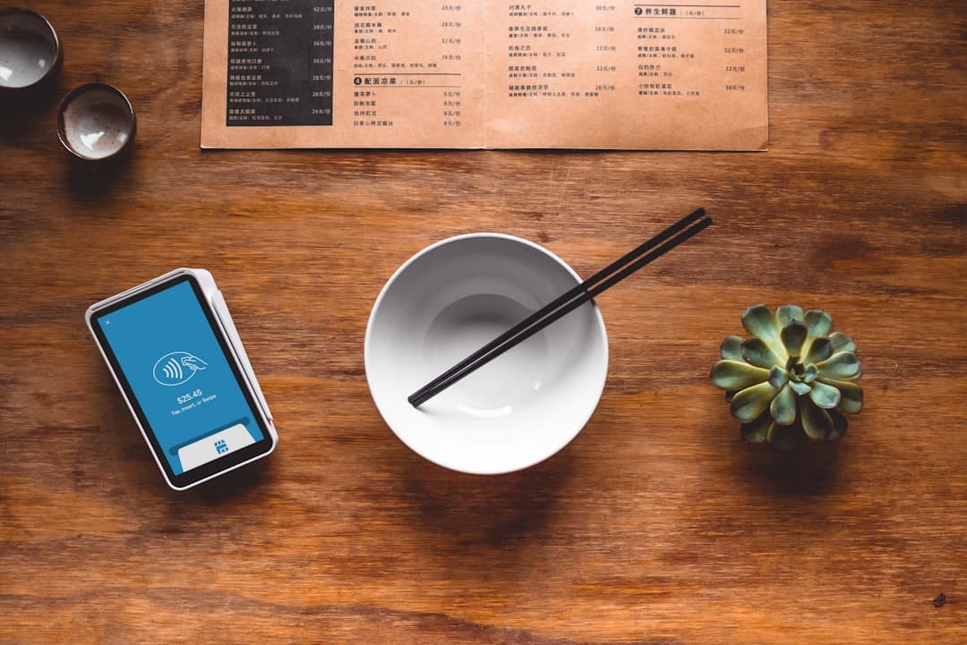 Restaurant manager reviewing online ordering payments while a customer uses a QR code menu