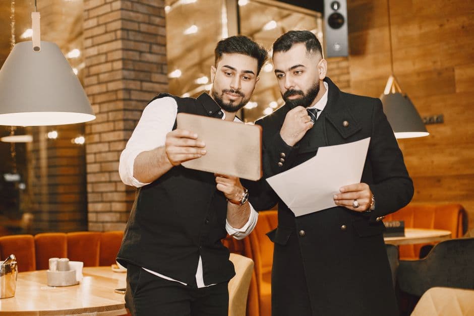 Restaurant operator reviewing digital menu analytics on a tablet