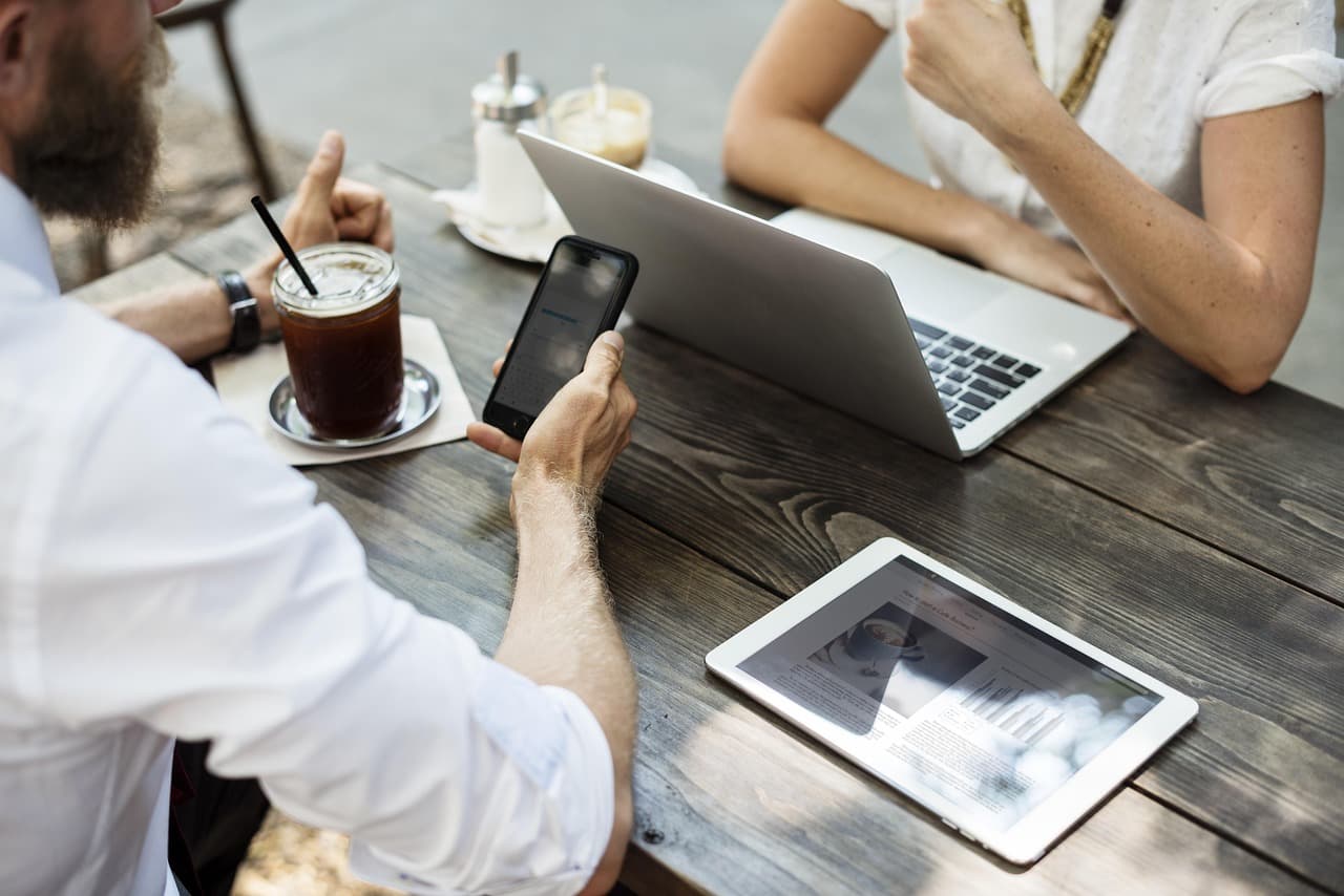 Restaurant owner reviewing a live website menu and online ordering flow on a laptop and phone