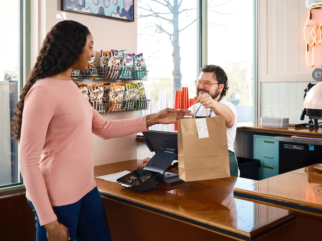 Restaurant manager reviewing prepaid pickup and scheduled online orders on a tablet