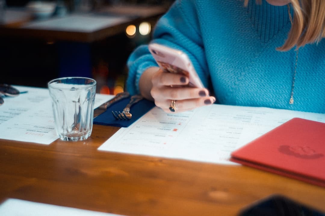 Restaurant manager capturing a printed menu with a phone for OCR import.