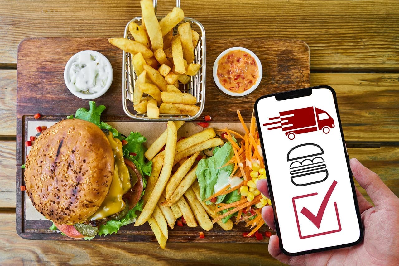 Staff member checking the live restaurant menu on a phone after publishing changes.