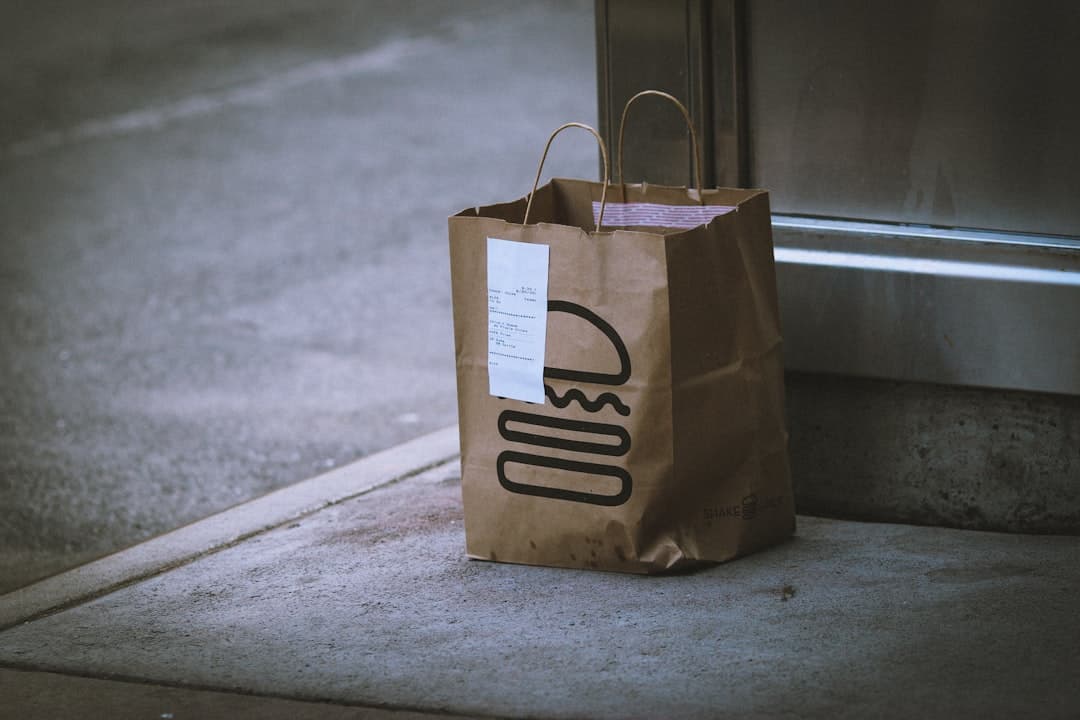 Staff handing off a clearly labeled large order at a restaurant pickup area
