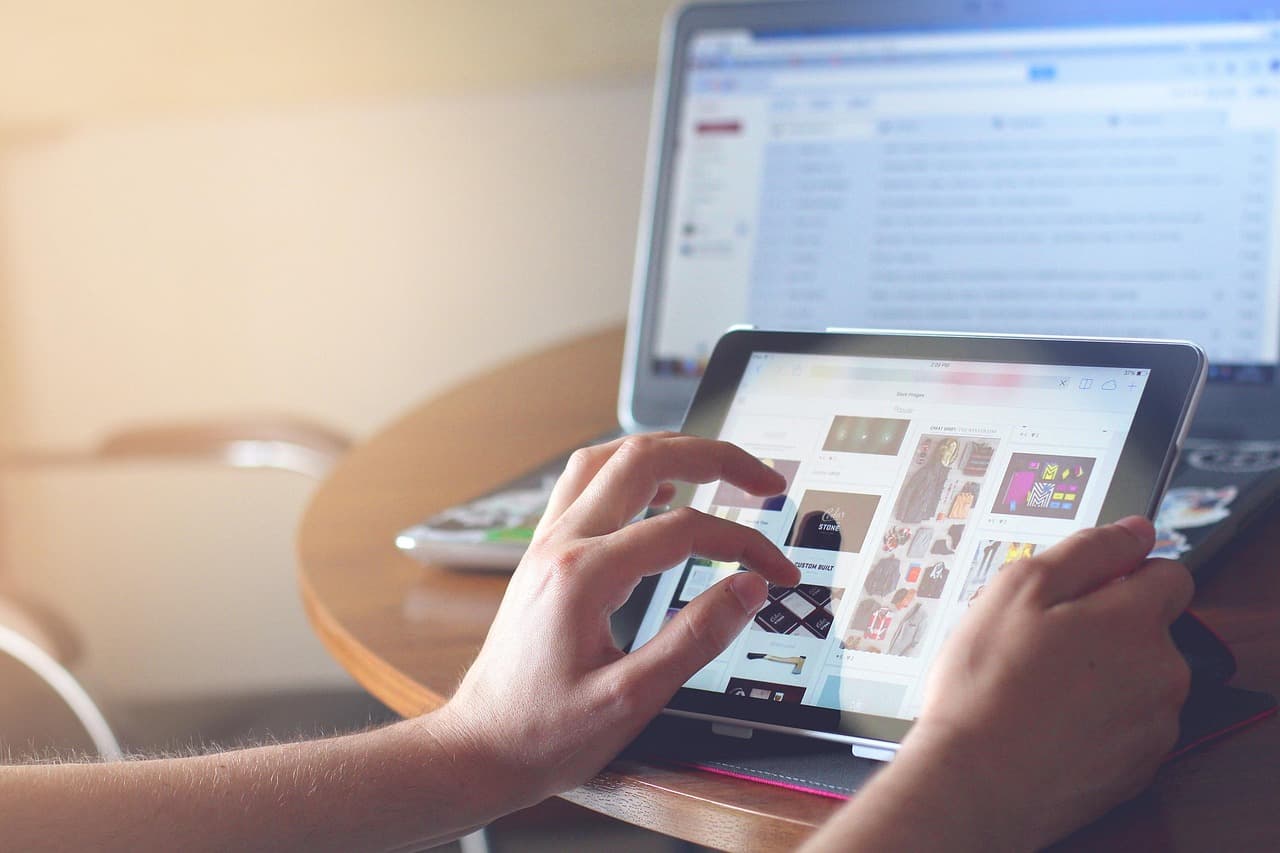 Chef and manager updating a sold-out menu item on a tablet during busy service.