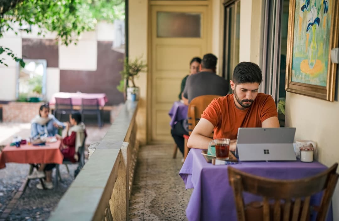Restaurant owner reviewing ROI worksheet inputs on a laptop.