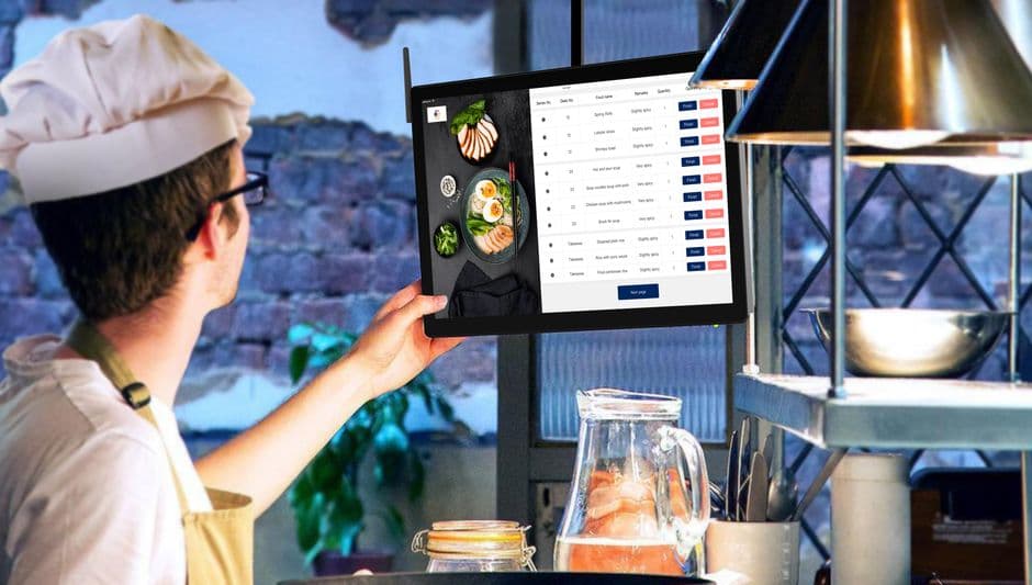 Restaurant team making digital menu updates based on weekly review findings